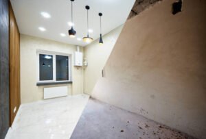 Side-by-side comparison of a bathroom before and after renovation, highlighting ceiling water damage and improvements made.