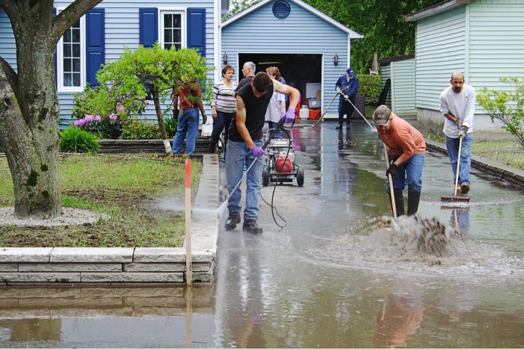 Emergency water damage repair team drying flooded property