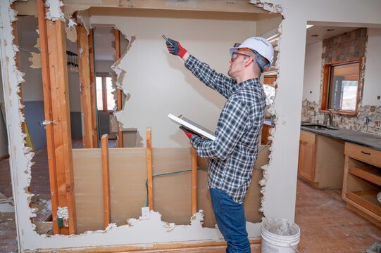 Builder reviewing contract during questions to ask remodeling contractors discussion