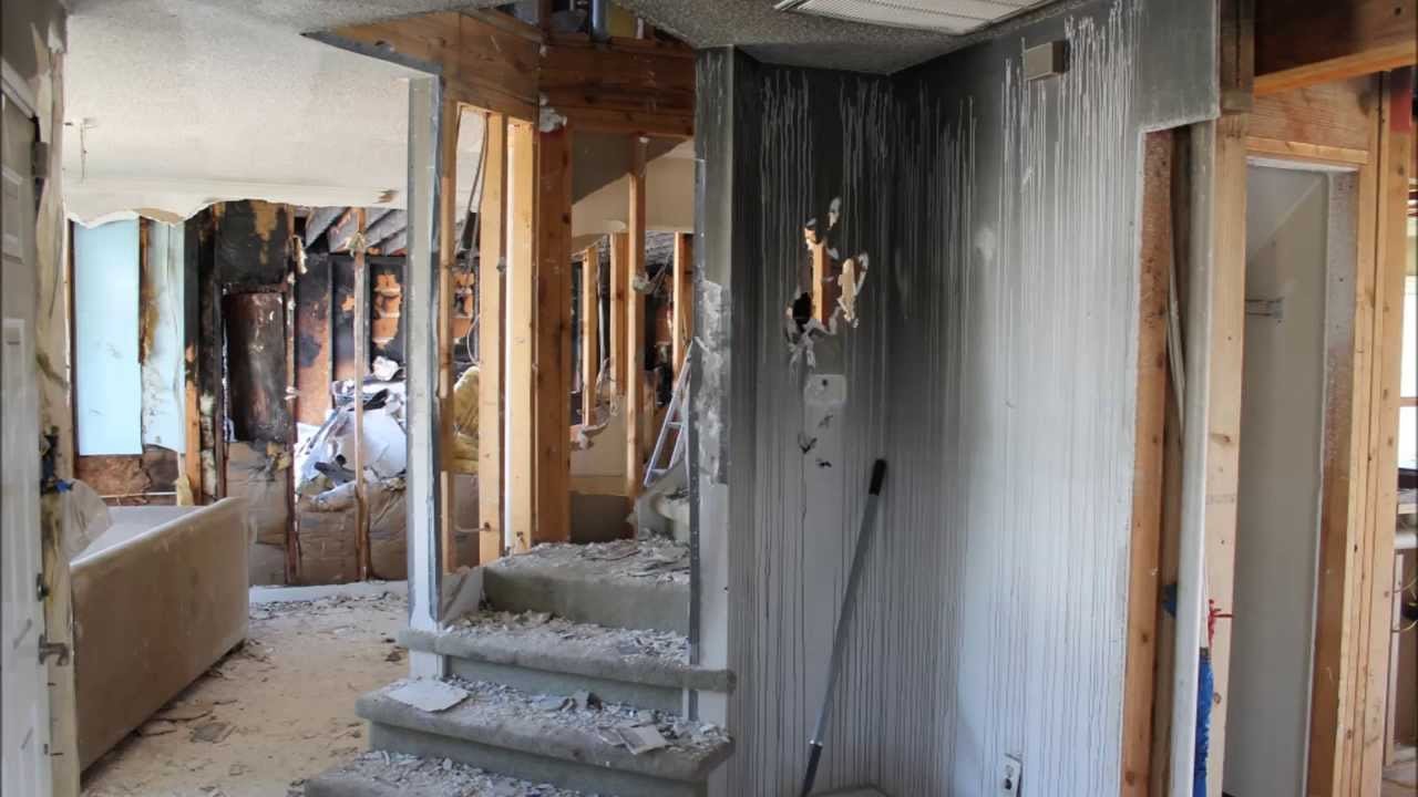 Fire Damage Restoration Service removing soot and smoke damage from kitchen walls